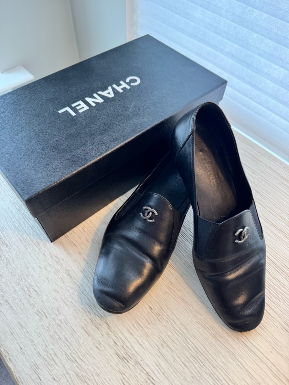 CHANEL Black Leather Slip-On Loafers with Silver CC Emblem